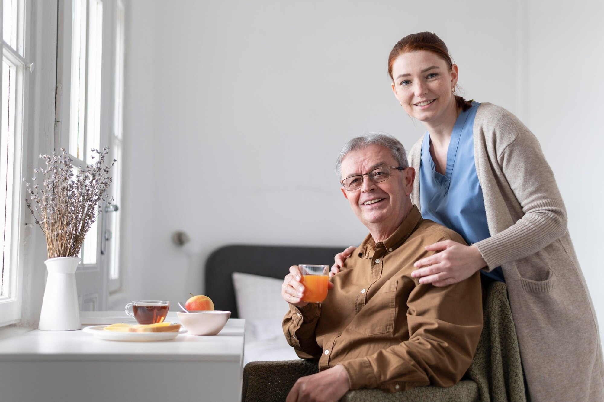 Caregiver helping senior with laptop