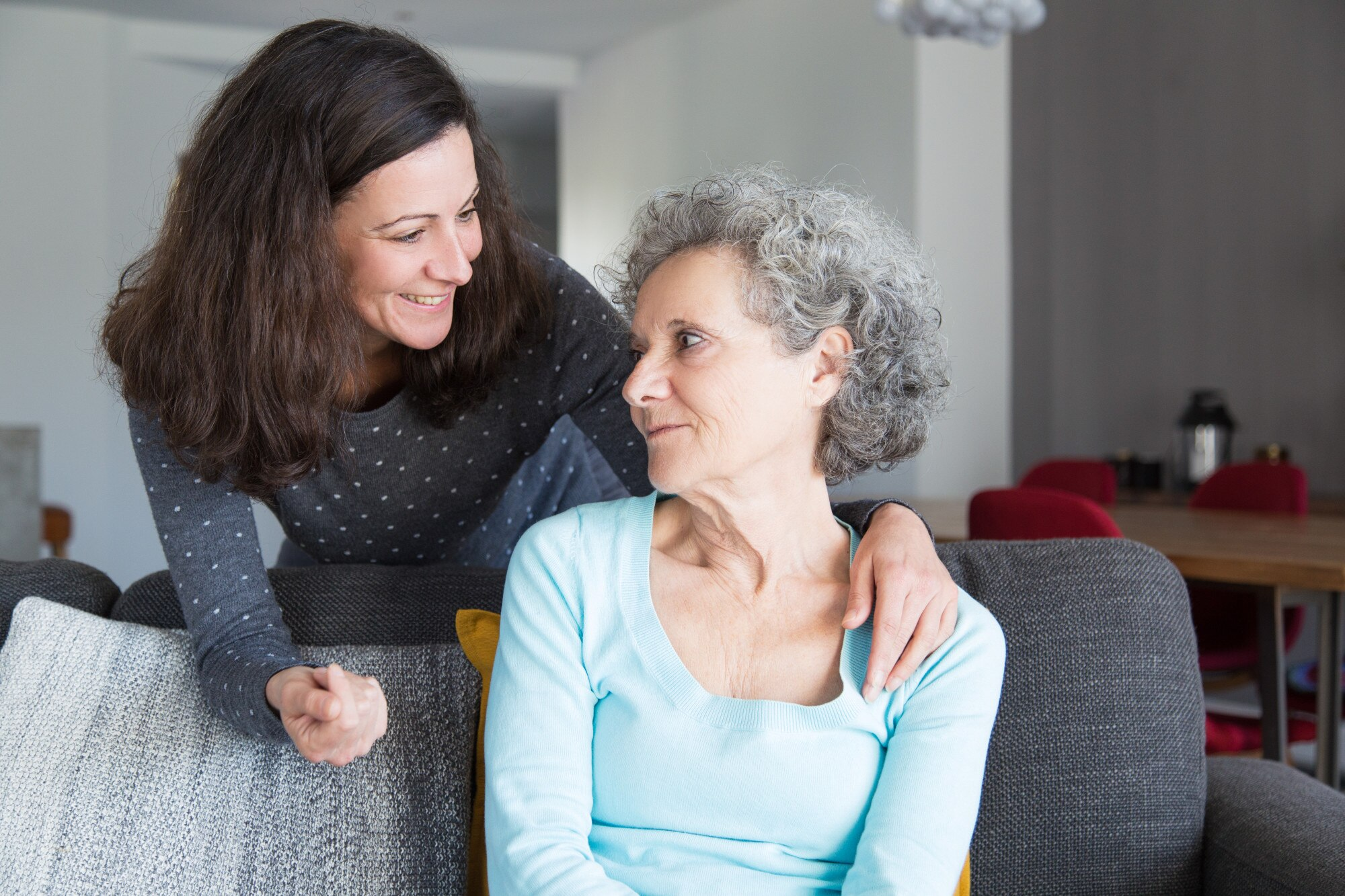 Caregiver helping elderly woman with activities