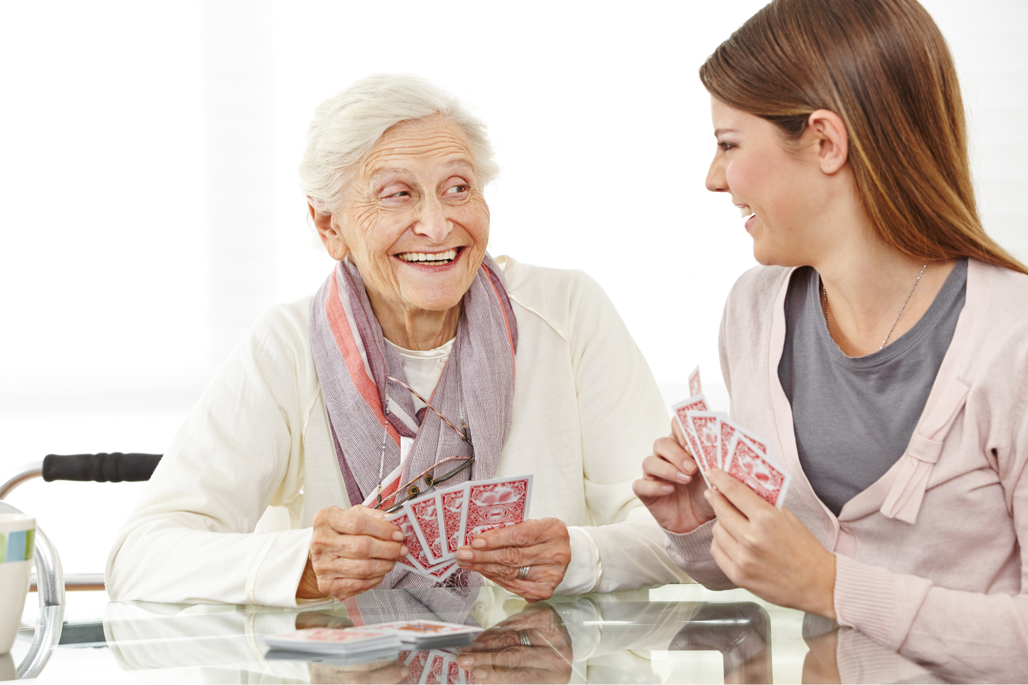 Caregiver helping senior with light gardening tasks